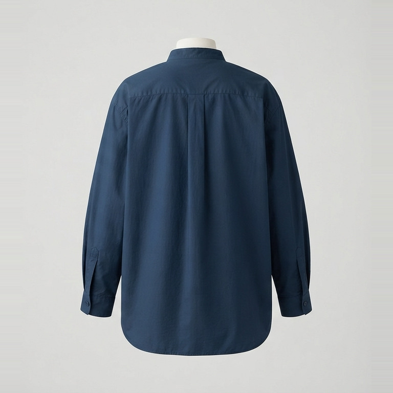 Back of the ink-blue blouse concept, showing full sleeves and a relaxed shape with a longer curved hem.